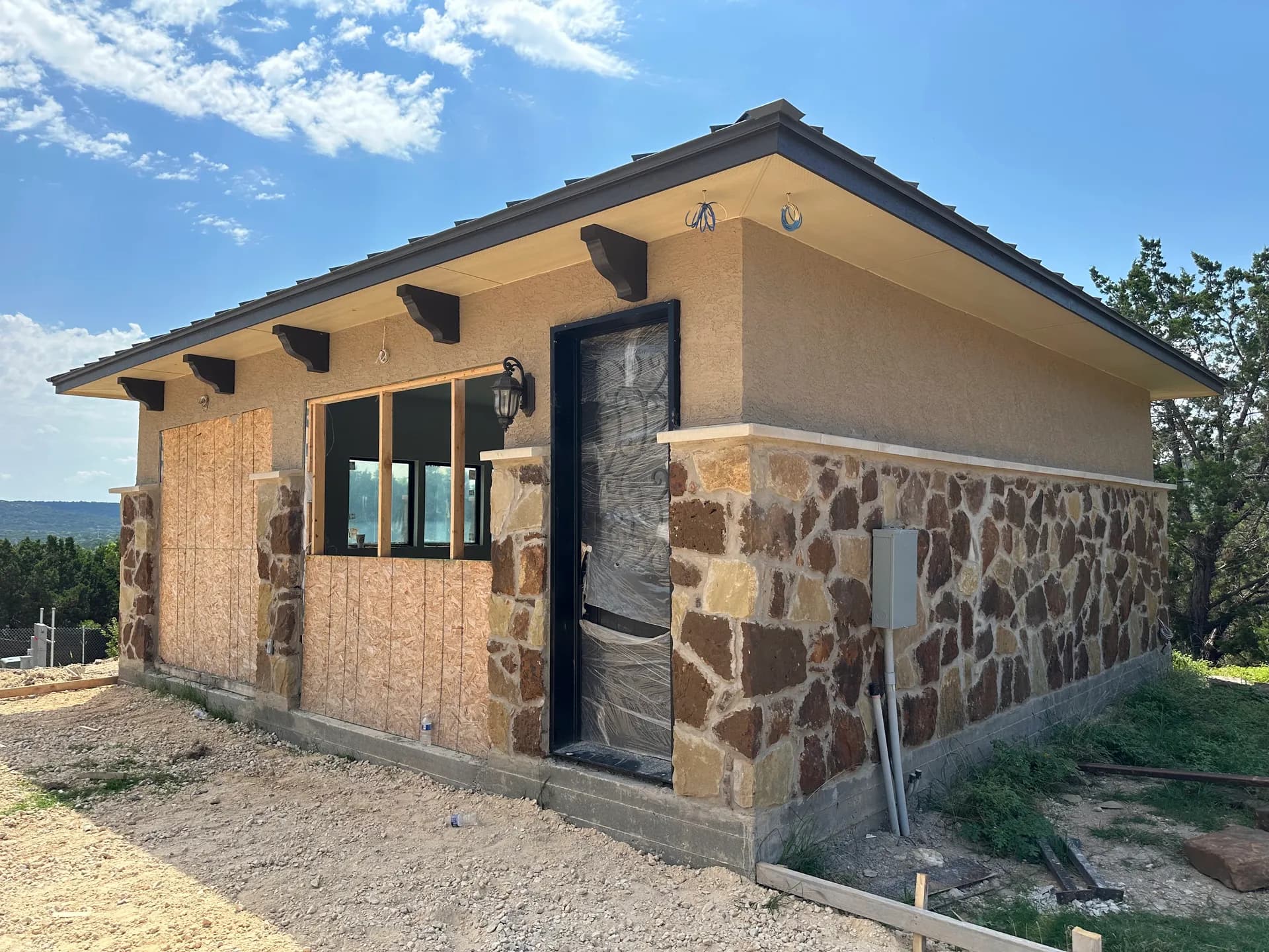 Exterior walls, roofline, and rafter tails in place while openings were still covered