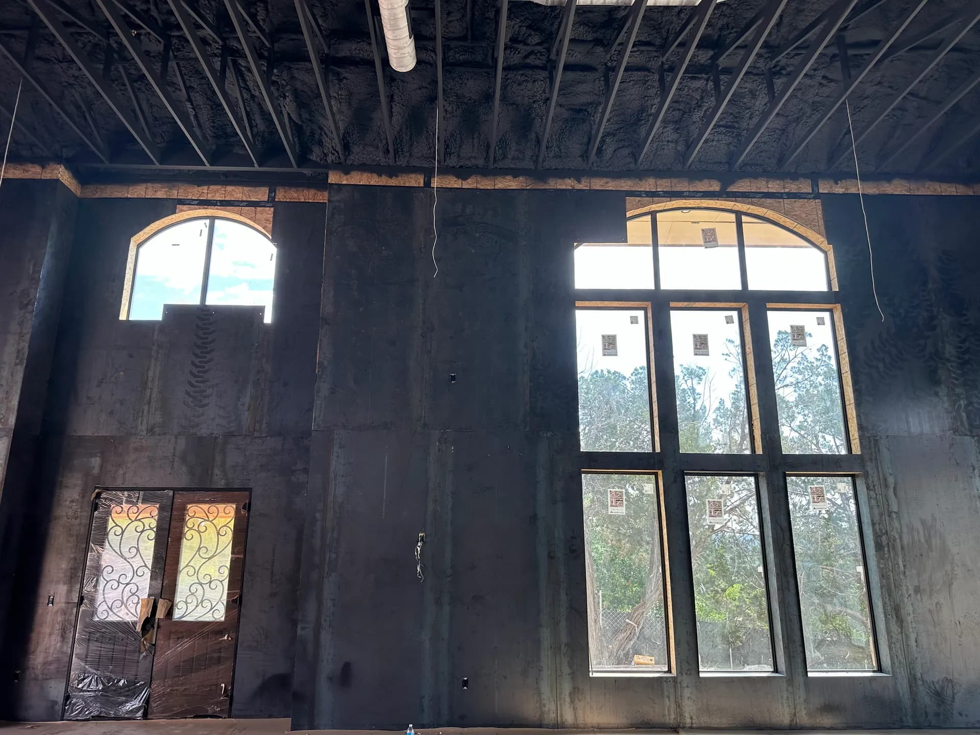 Tall arched openings in the main volume before interior finishes