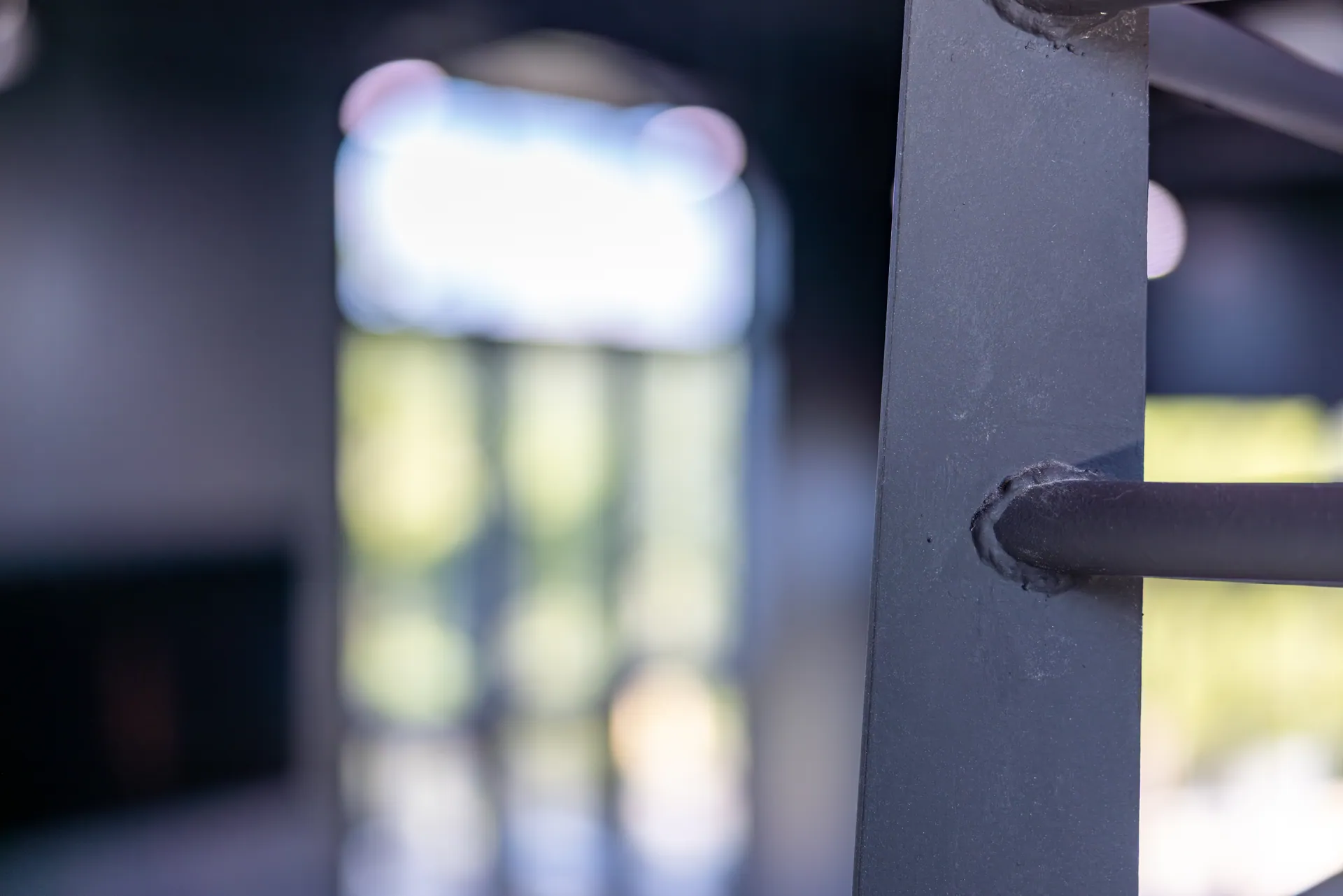 Close view of the welded connection between a metal rail and its post