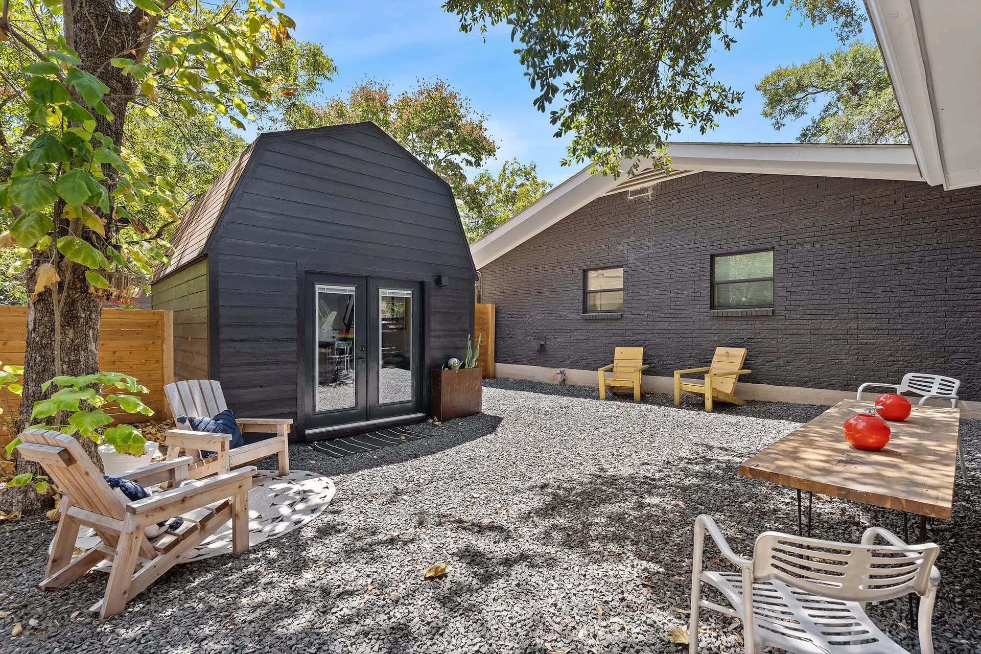 Dark shed conversion and gravel courtyard at Domain’s East Austin Tuff Shed ADU