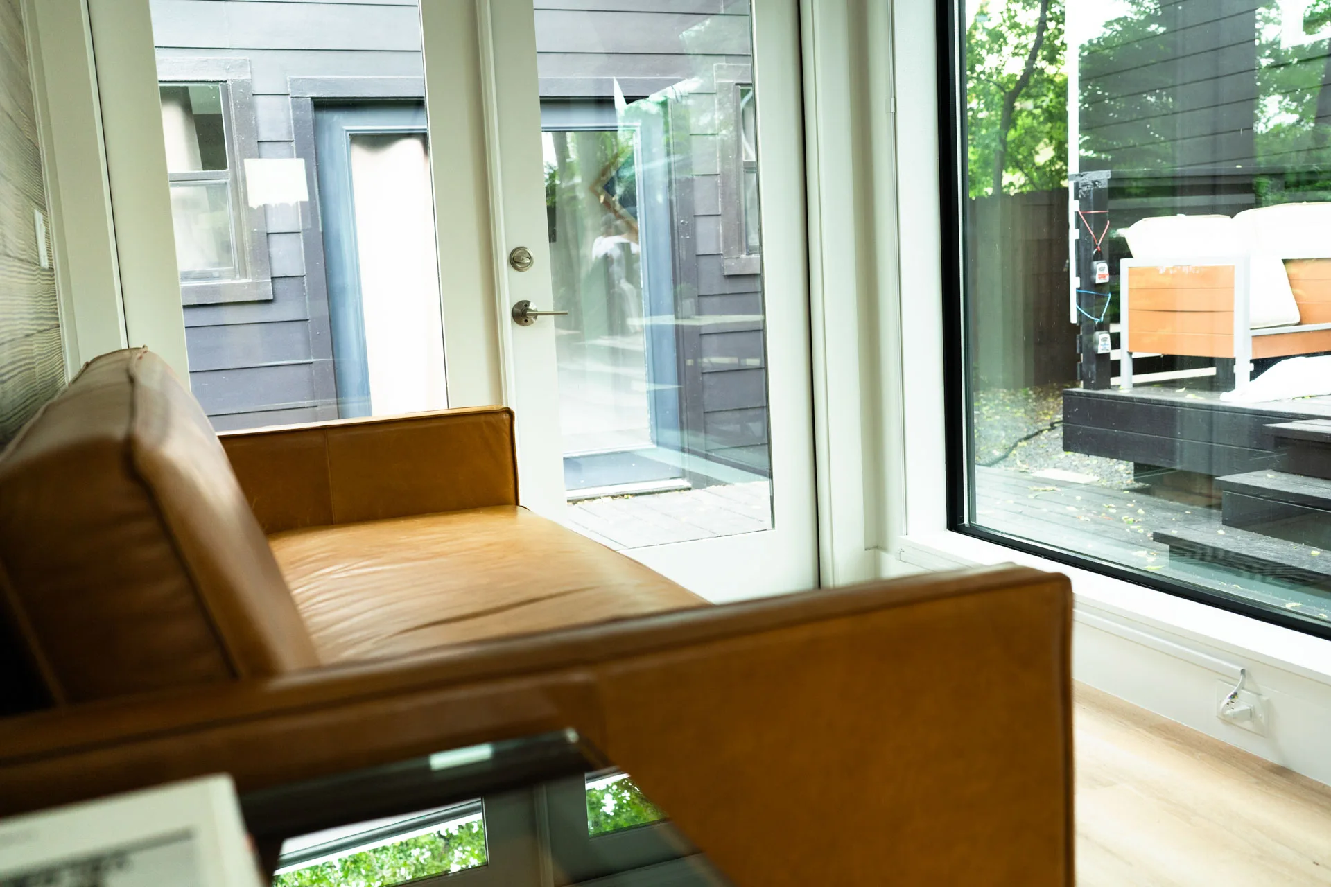 Seating beside full-height garden windows in Domain’s Black Container ADU