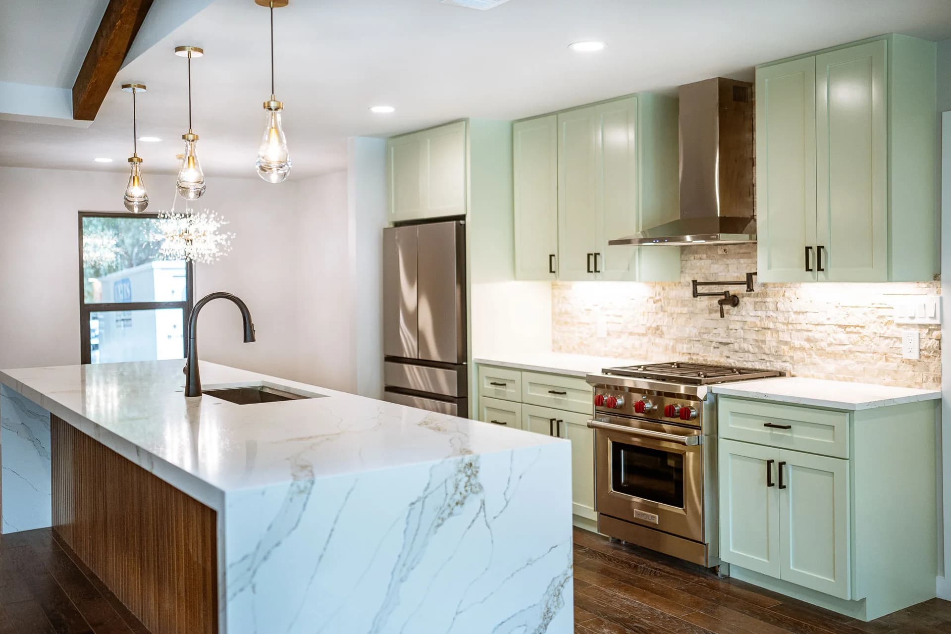 Waterfall island and custom kitchen cabinetry in Domain’s Northwest Austin remodel